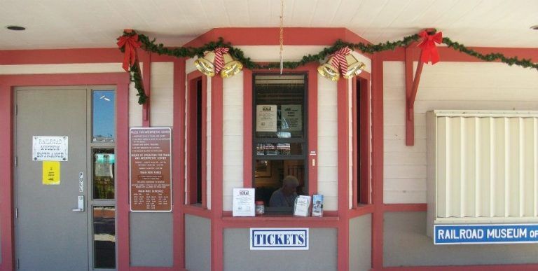 Ticket booth with red and white trim, labeled 