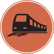 Black silhouette of a train on tracks inside an orange circle.