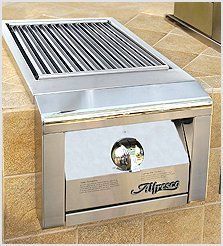 A stainless steel grill is sitting on top of a brick wall.