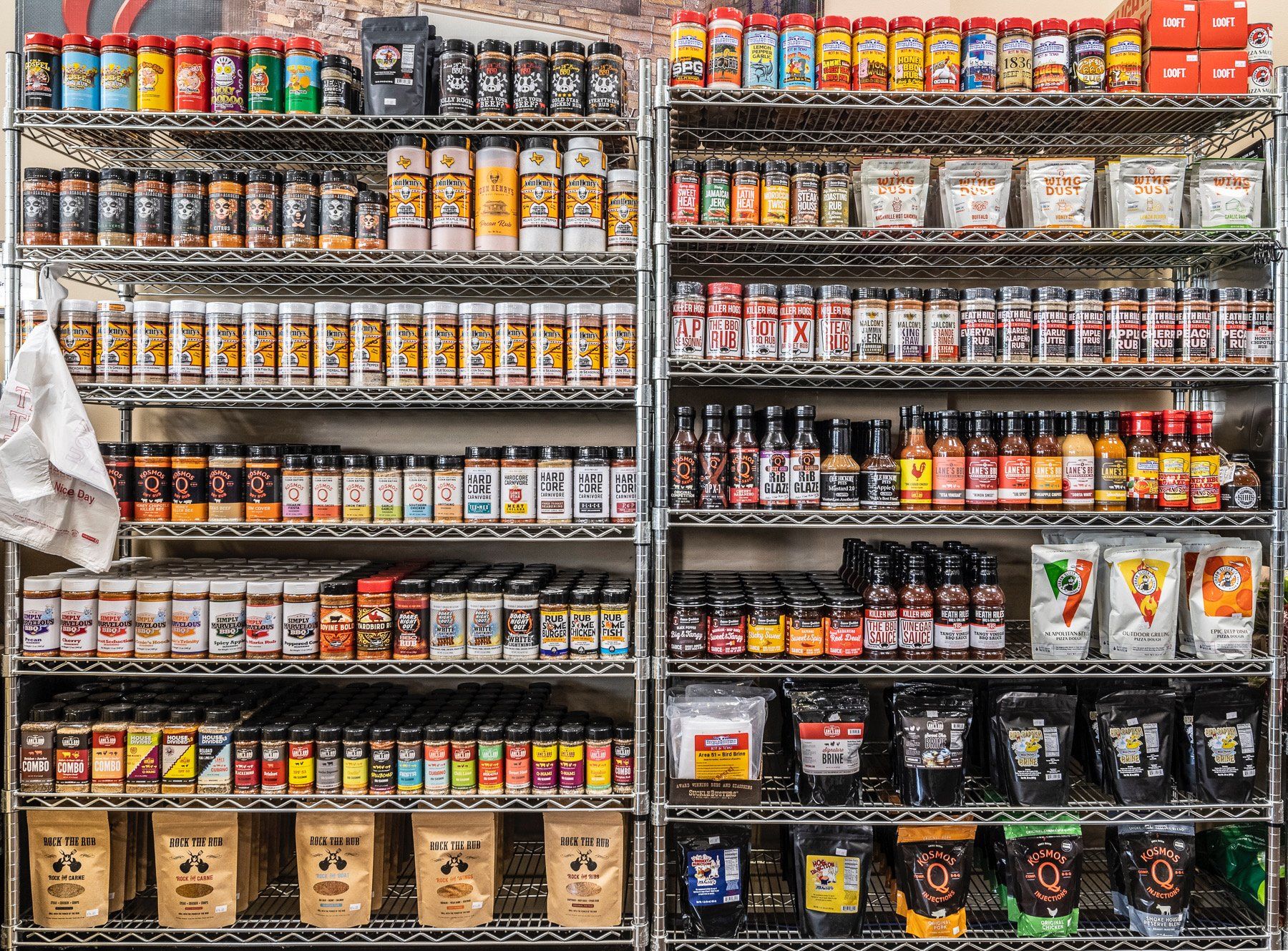 a store shelf filled with lots of spices and condiments for grilling