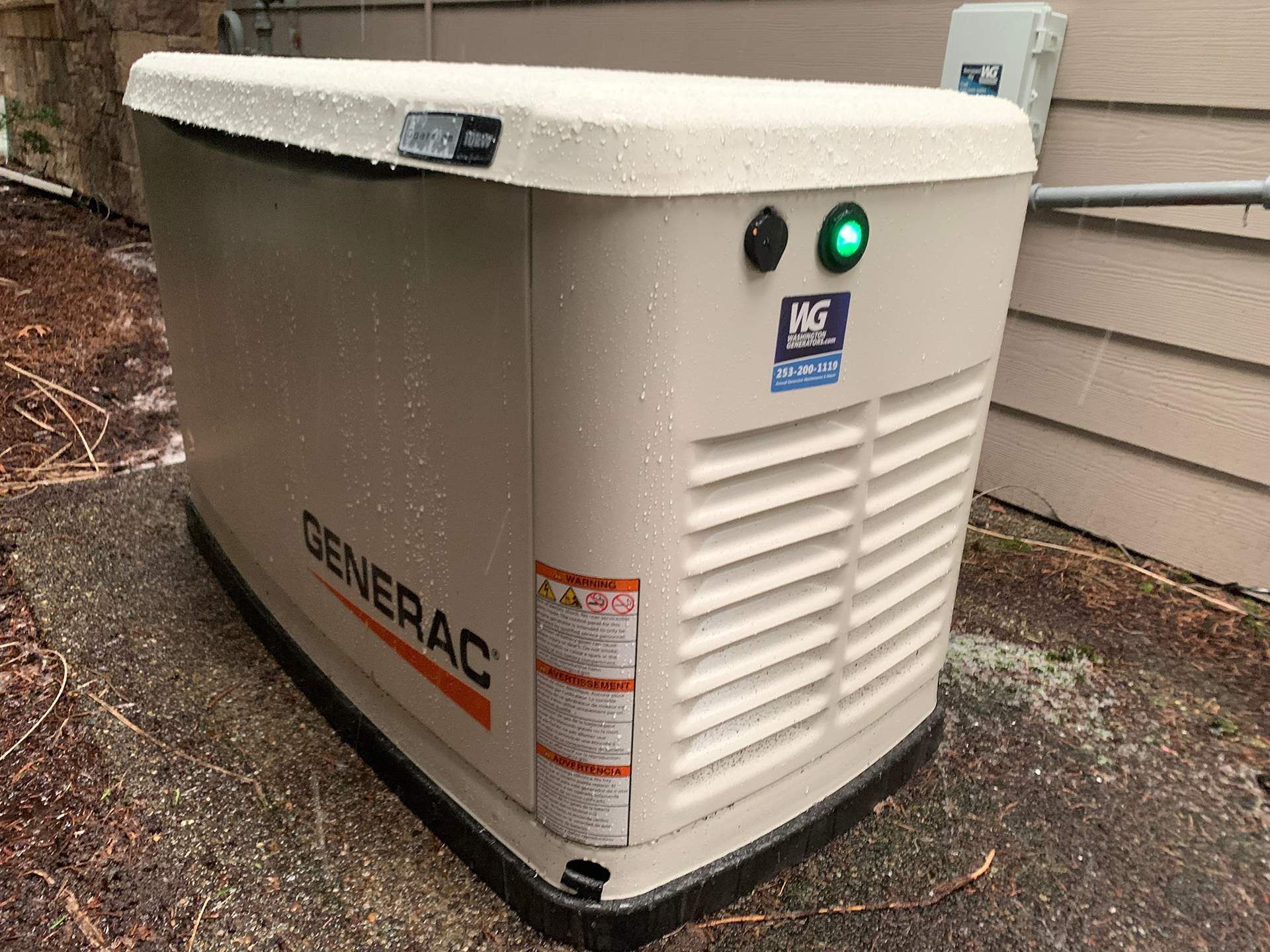 A Generac standby generator on a concrete pad with a green light illuminated.
