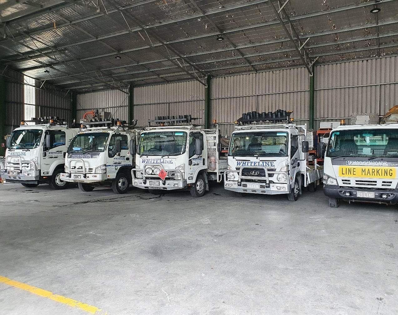 A Row of Trucks Are Parked in a Warehouse | Beresfield, NSW | Whiteline Road Services