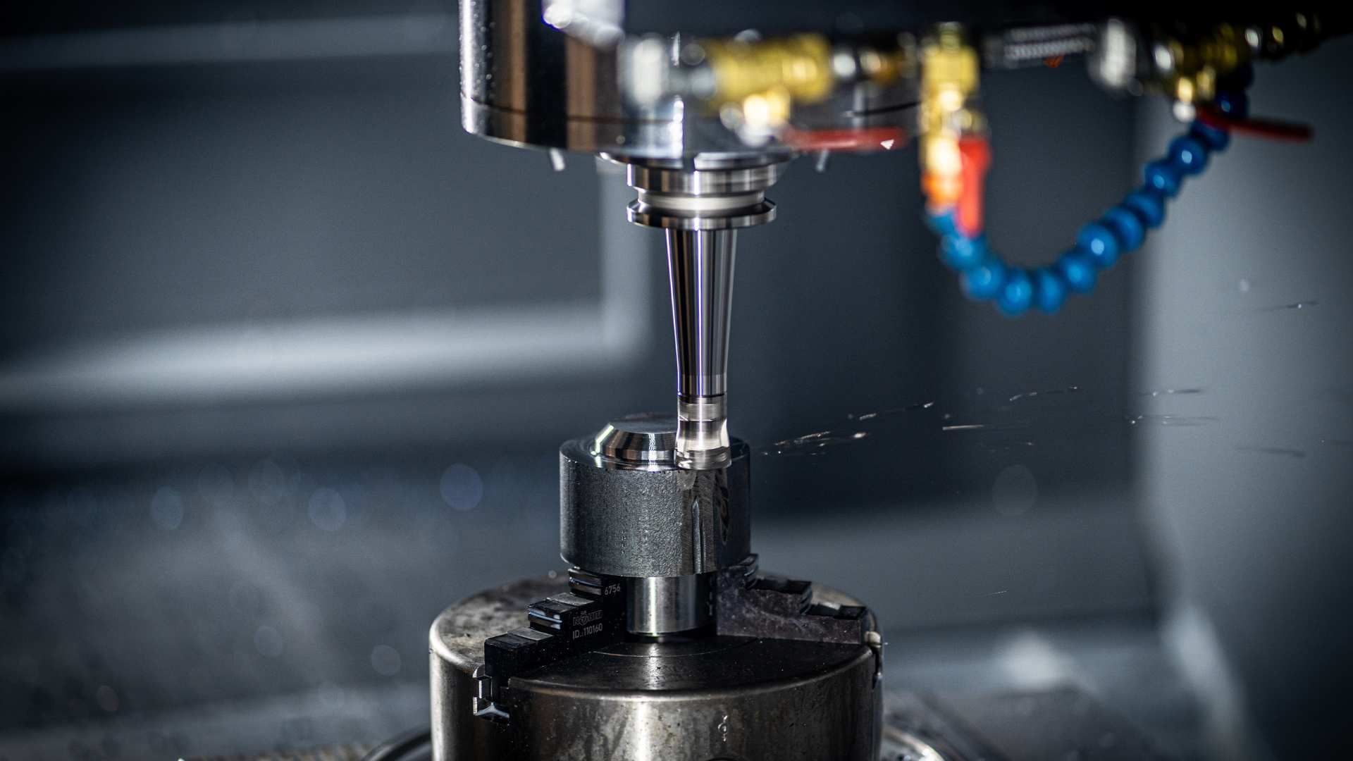 Laser cutting metal sheet with glowing sparks in an industrial workshop