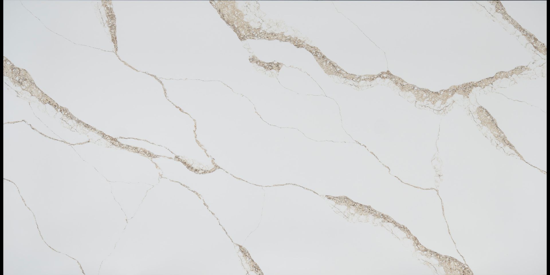 A close up of a white quartz counter top with a marble texture.