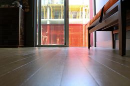 A room with a wooden floor and a sliding glass door