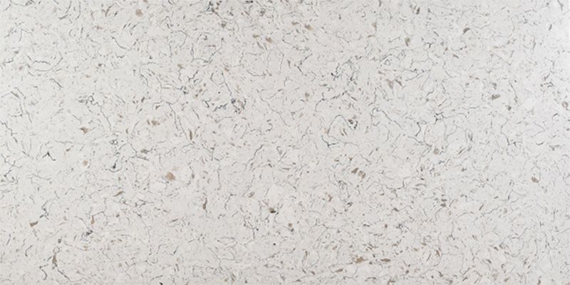 A close up of a white granite counter top.