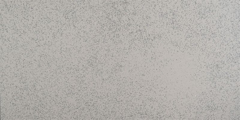 A close up of a white tile with a grainy texture.