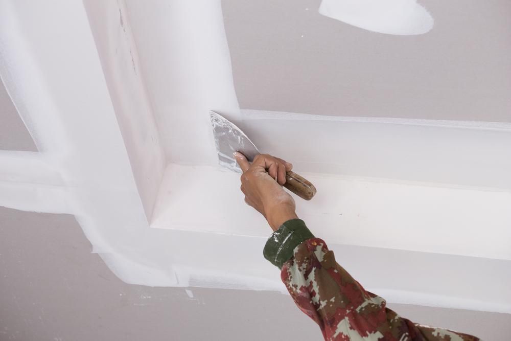 Person using a trowel to apply compound — Patch Plaster Paint in Johnston, NT