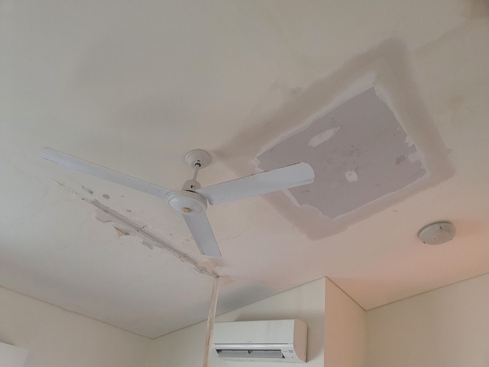 White ceiling with ceiling fan and a square patch of repaired drywall — Patch Plaster Paint in Johnston, NT