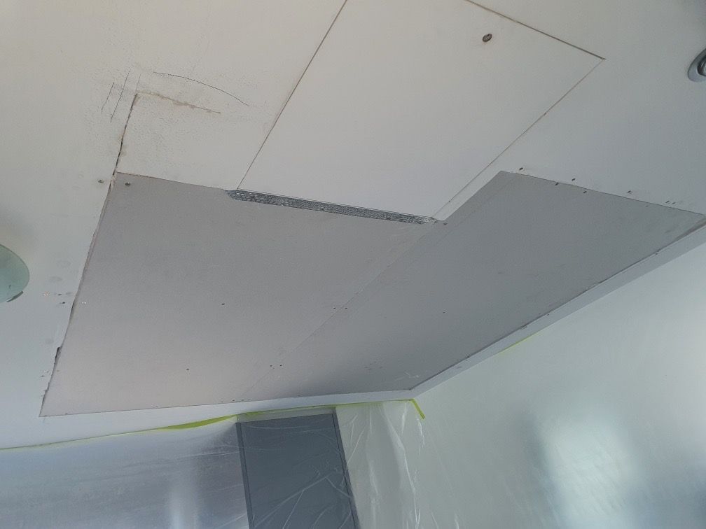 Ceiling with a rectangular hole cut out for repair; plastic sheeting protects the walls — Patch Plaster Paint in Johnston, NT