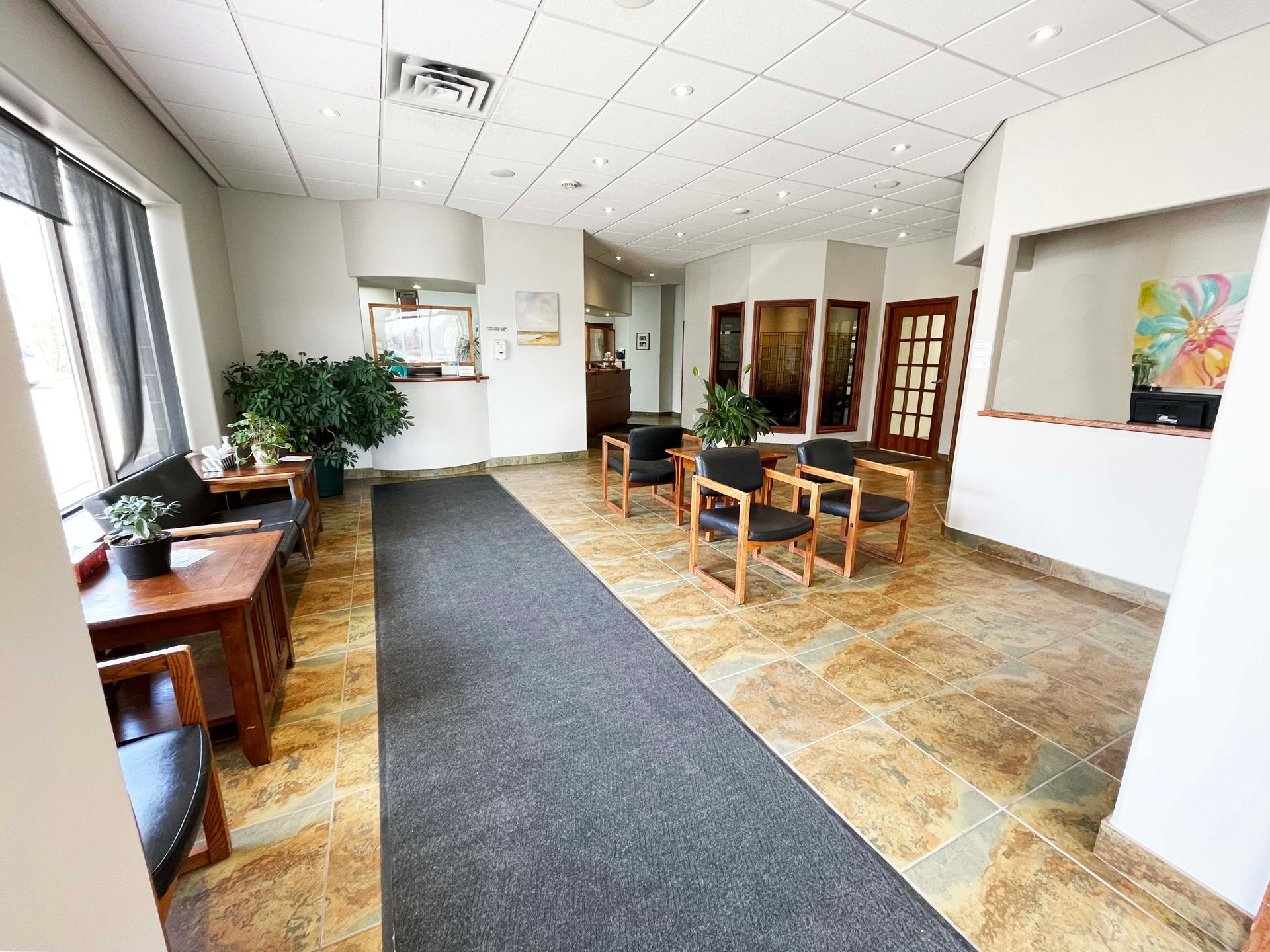 A waiting room with chairs and tables in a hospital