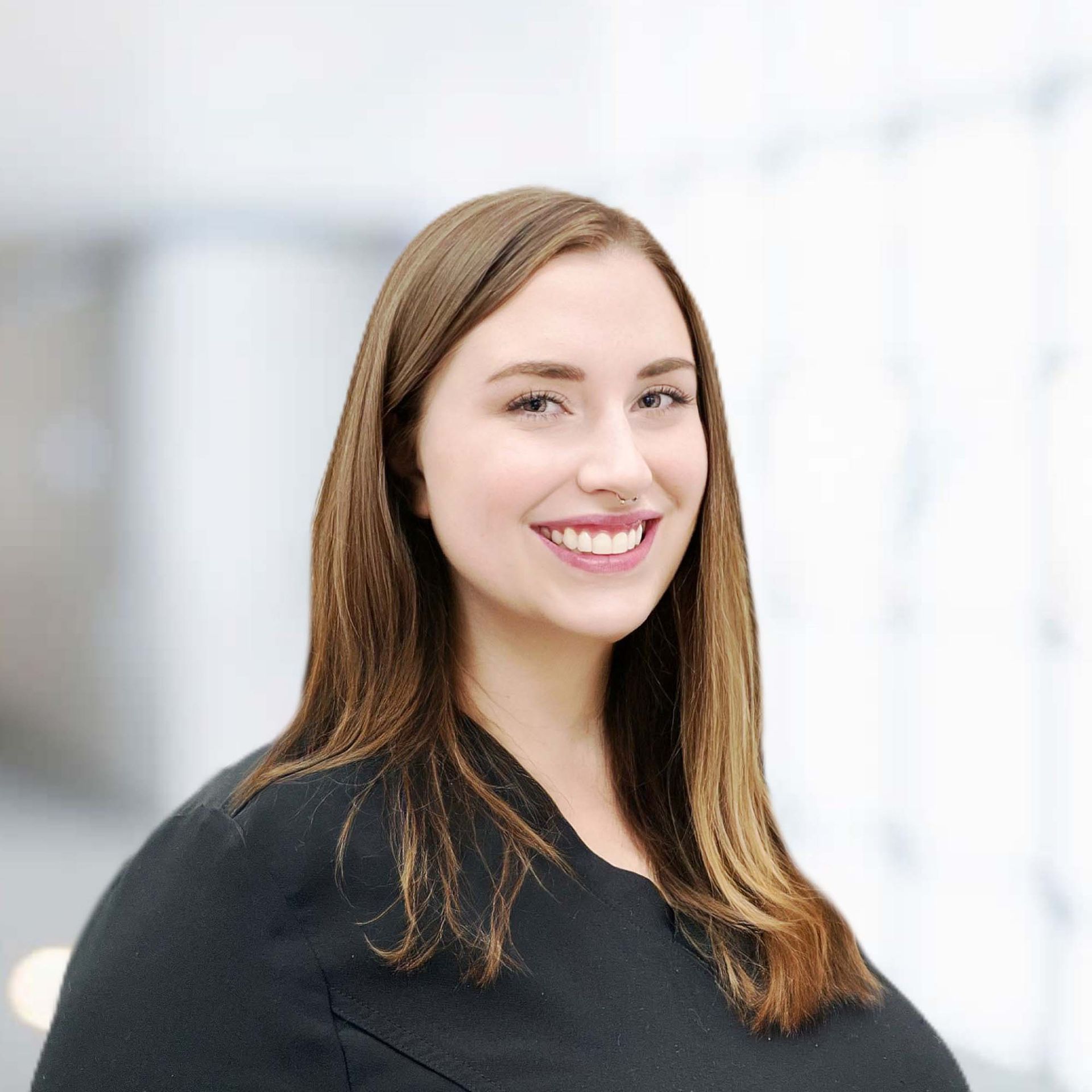 A woman in a black shirt is smiling for the camera