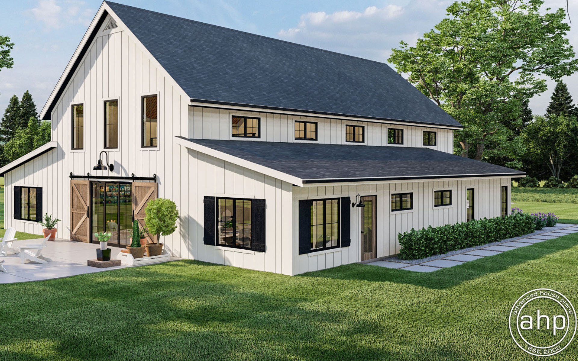 A modern white farmhouse with black trim, a gabled roof, and wooden sliding barn doors on a grassy lawn.