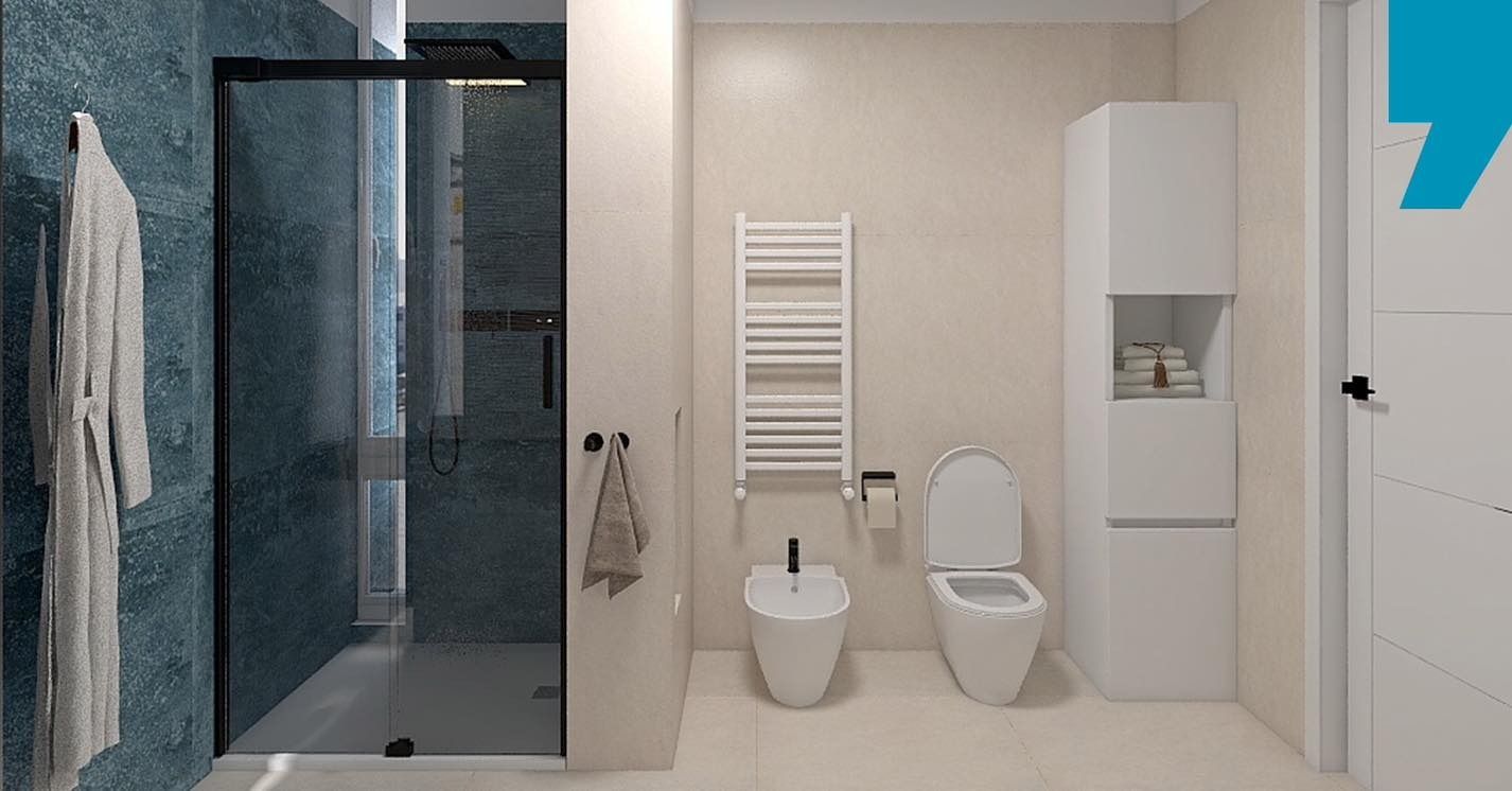 Bagno moderno con doccia in vetro, WC, bidet, mobiletto sottolavabo e termoarredo su pareti beige.