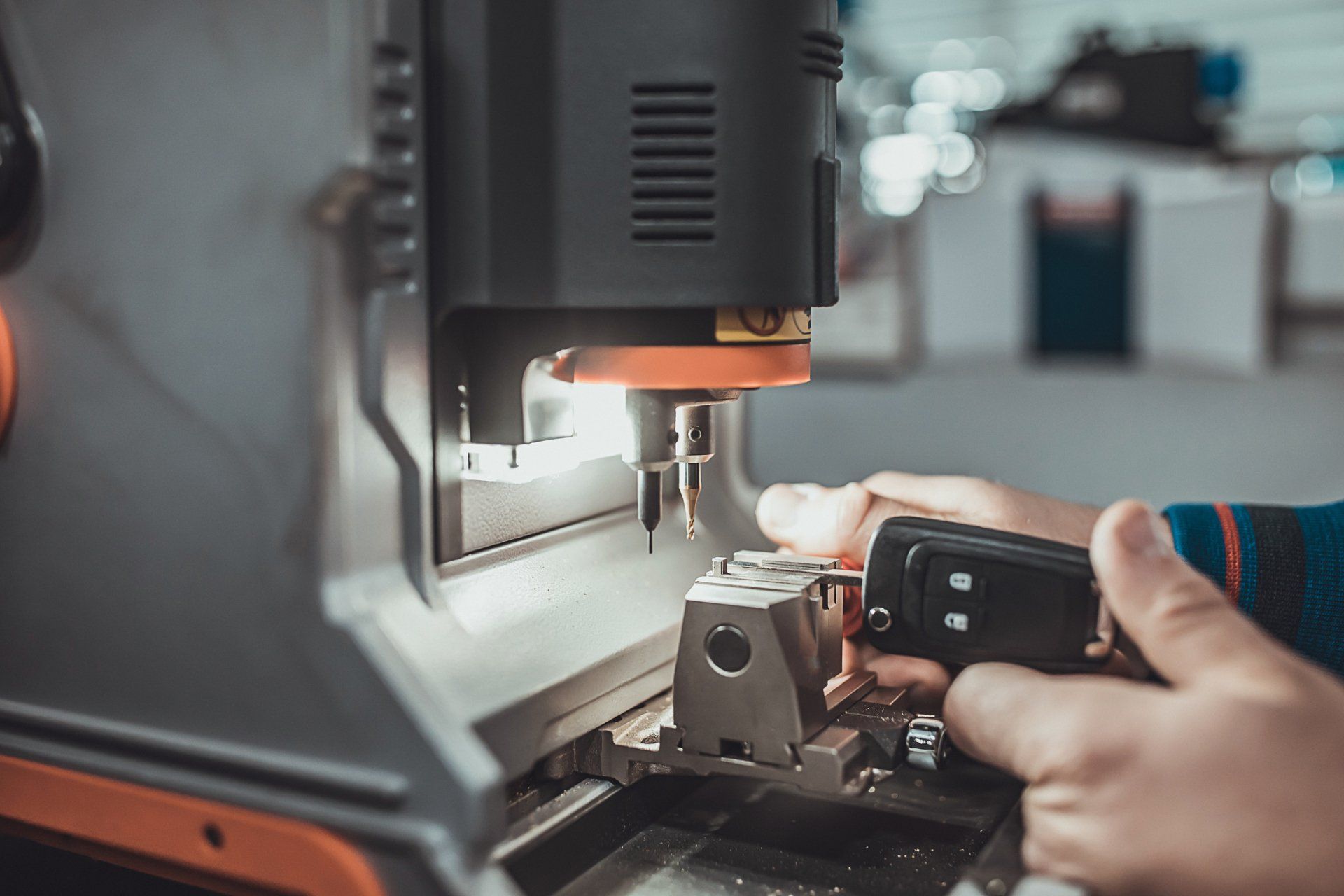 Locksmith Cutting Car Key with His Machine — Collegeville, PA — Precision Auto Key Locksmith Cutting Car Key with His Machine — Collegeville, PA — Precision Auto Key
