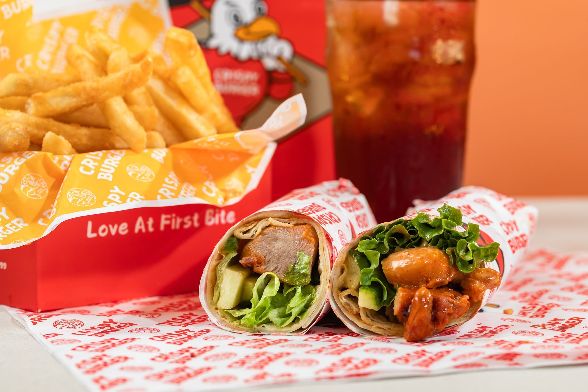 Fast-food meal with fries, two wrapped sandwiches, and a soda on a tray