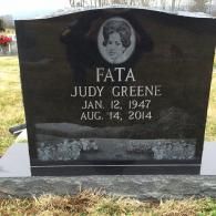 Black granite headstone for Judy Greene Fata, featuring her portrait and dates Jan 12, 1947 to Aug 14, 2014.