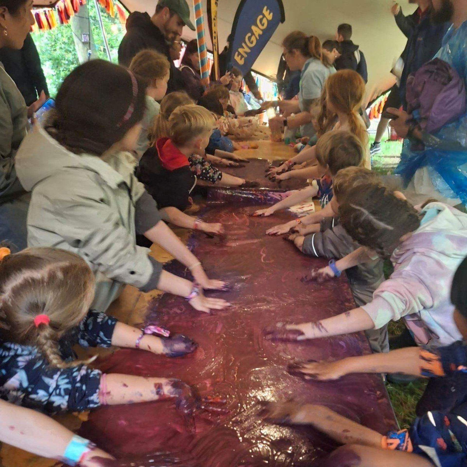 children playing with colored paints in their hands