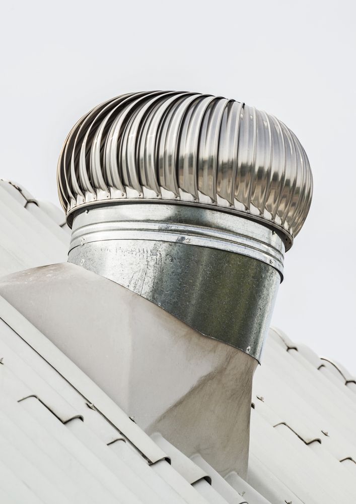 Metallic Roof Turbine Vent on a White Rooftop — Vision Roofing Fascia & Gutter in Hervey Bay, QLD