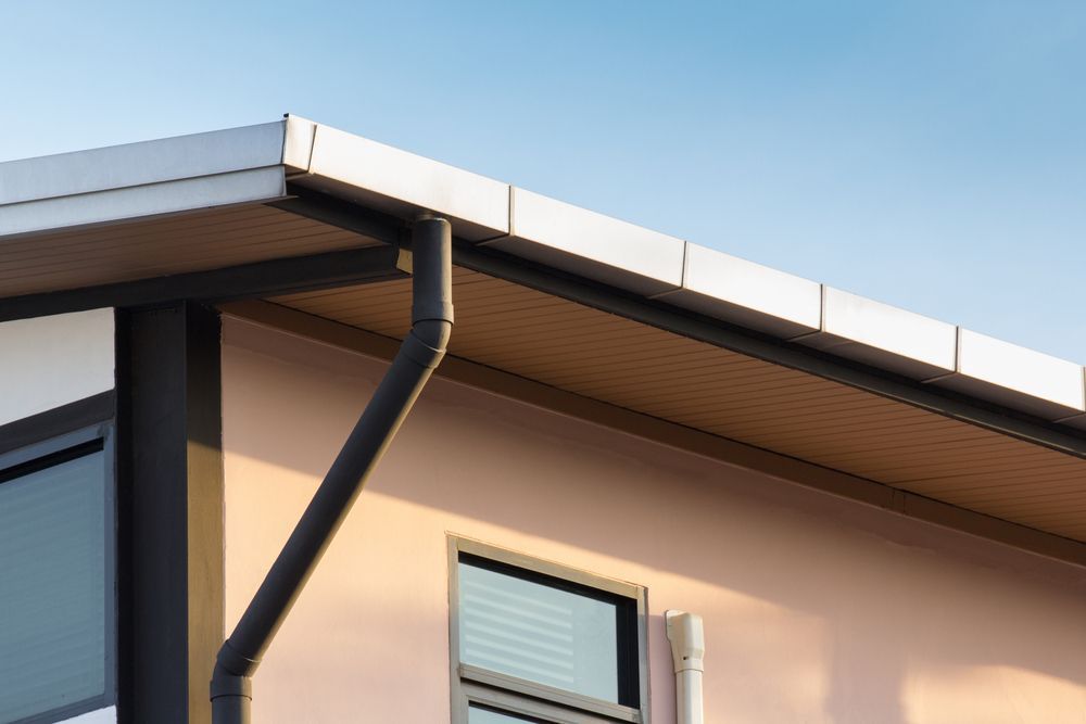 Close-up of a House Exterior Featuring a Black Gutter System — Vision Roofing Fascia & Gutter in Burrum Heads, QLD