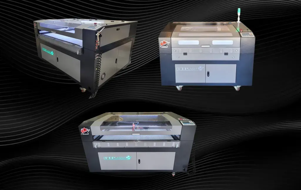Three laser engraving machines on a dark background.