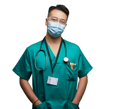 Medical professional in green scrubs, wearing a face mask and stethoscope, standing with hands in pockets.