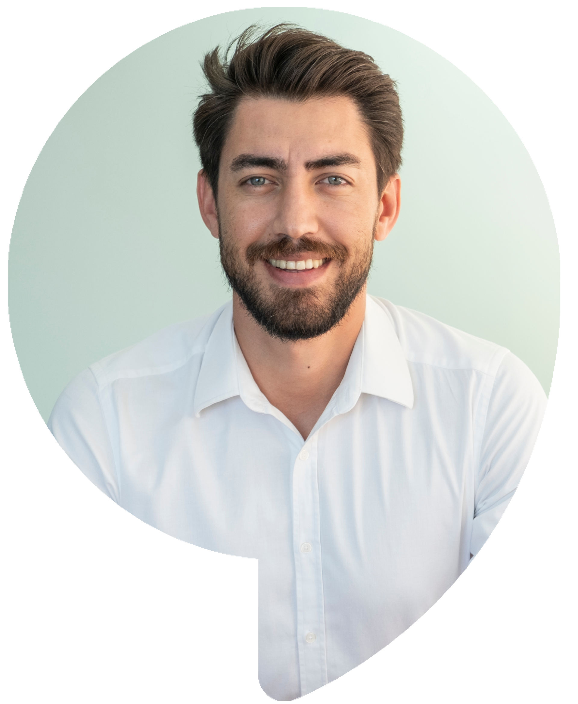Man with beard smiling, wearing a white shirt, against a light blue background.