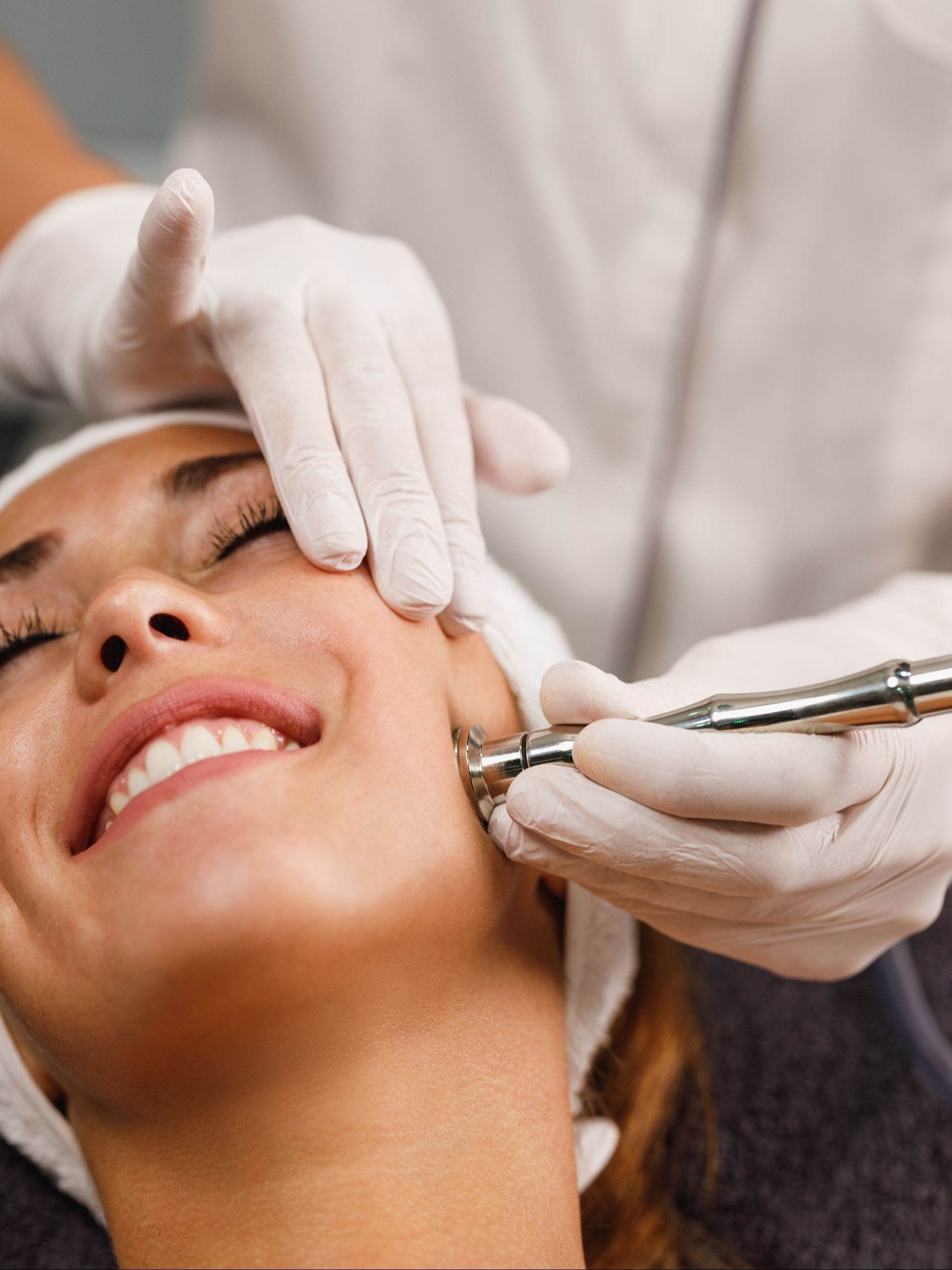 A woman is getting a facial treatment at a beauty salon.