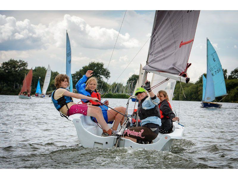 A group of people are sailing a boat on a lake.