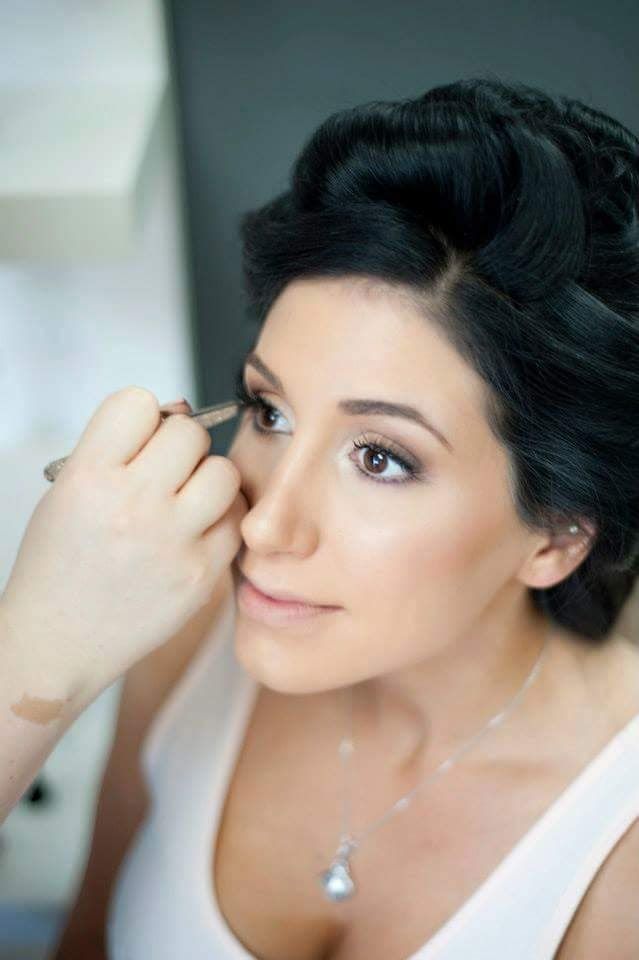 Katie C, Makeup Artist applying makeup to bride, behind the scenes.