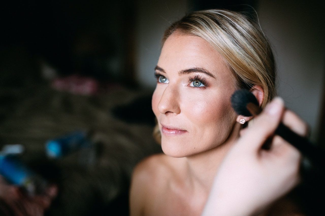 Katie C, Makeup Artist applying makeup to bride, behind the scenes.