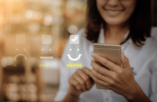 Woman smiling while using a smartphone with app icons overlayed on a blurred warm-toned background