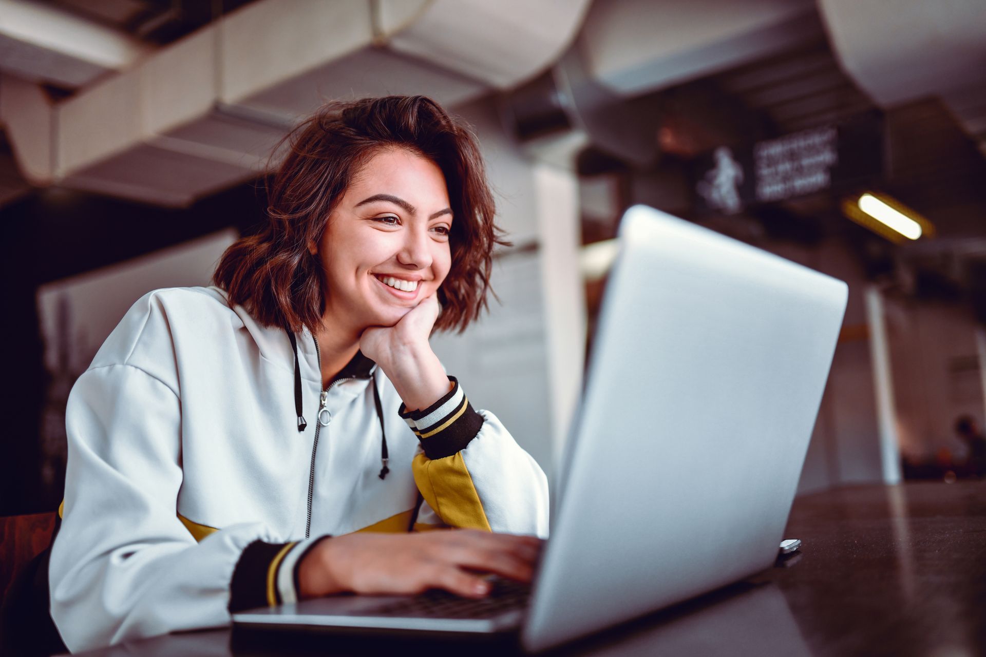 A happy woman using her Apple computer after a successful repair.