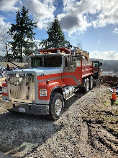Red and silver International dump truck on a construction site.