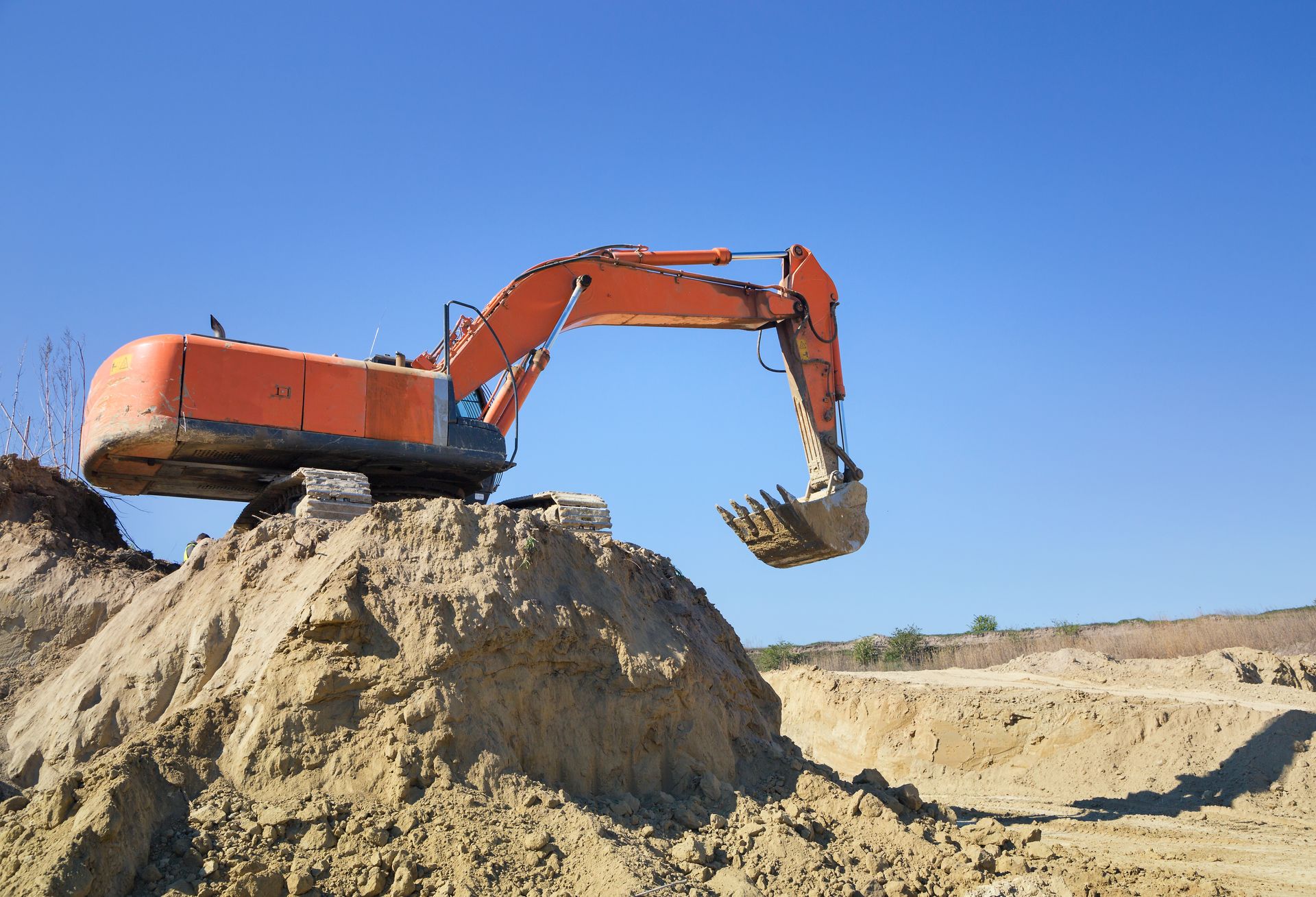 Huge crawler excavator and a construction dump truck at work on sand quarry. Huge crawler excavator and a construction dump truck at work on sand quarry.