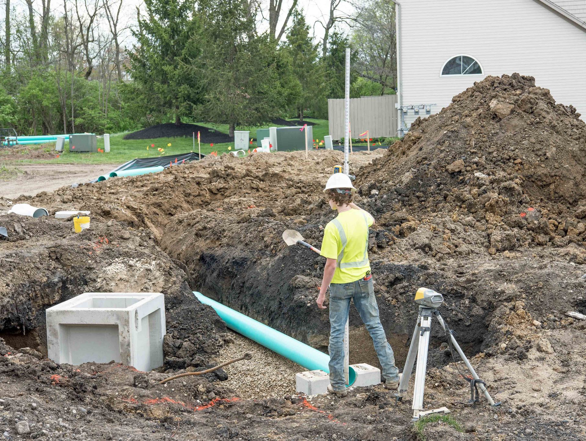 Utility trench excavation with the contractor installing underground PVC piping. Utility trench excavation with the contractor installing underground PVC piping.