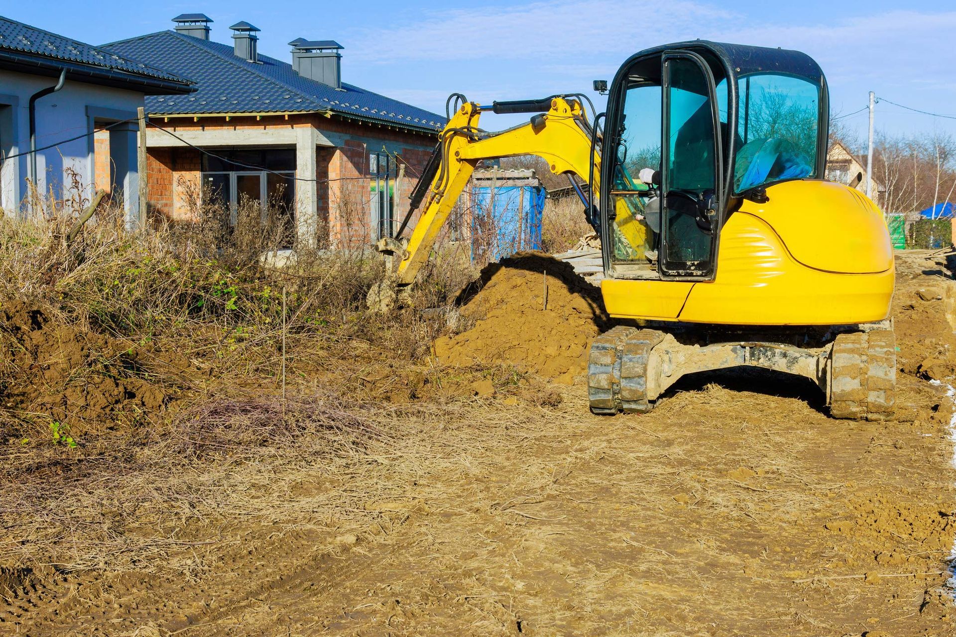 yellow excavator digging soil at a residential property yellow excavator digging soil at a residential property