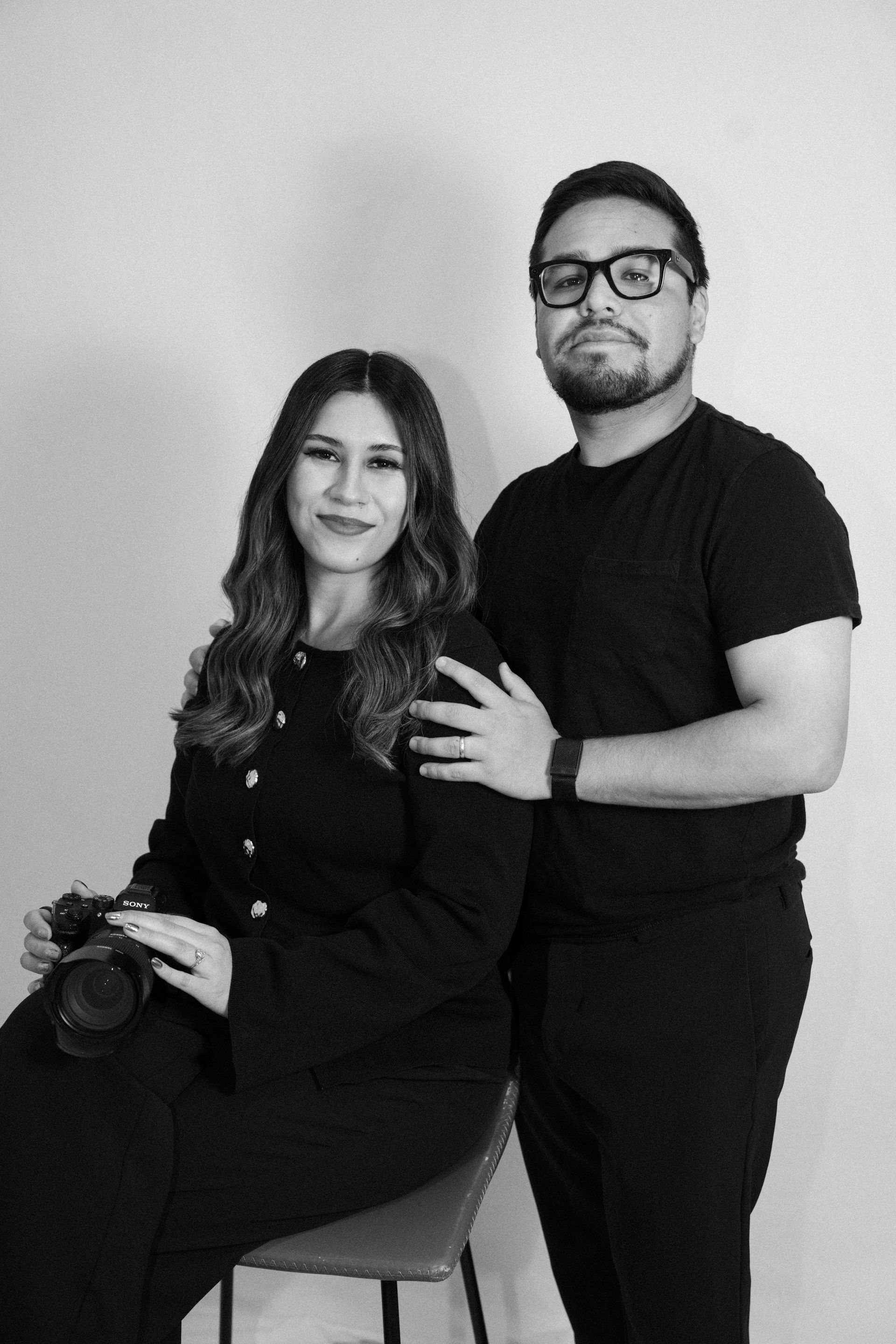 A man and a woman are hugging each other in a field.