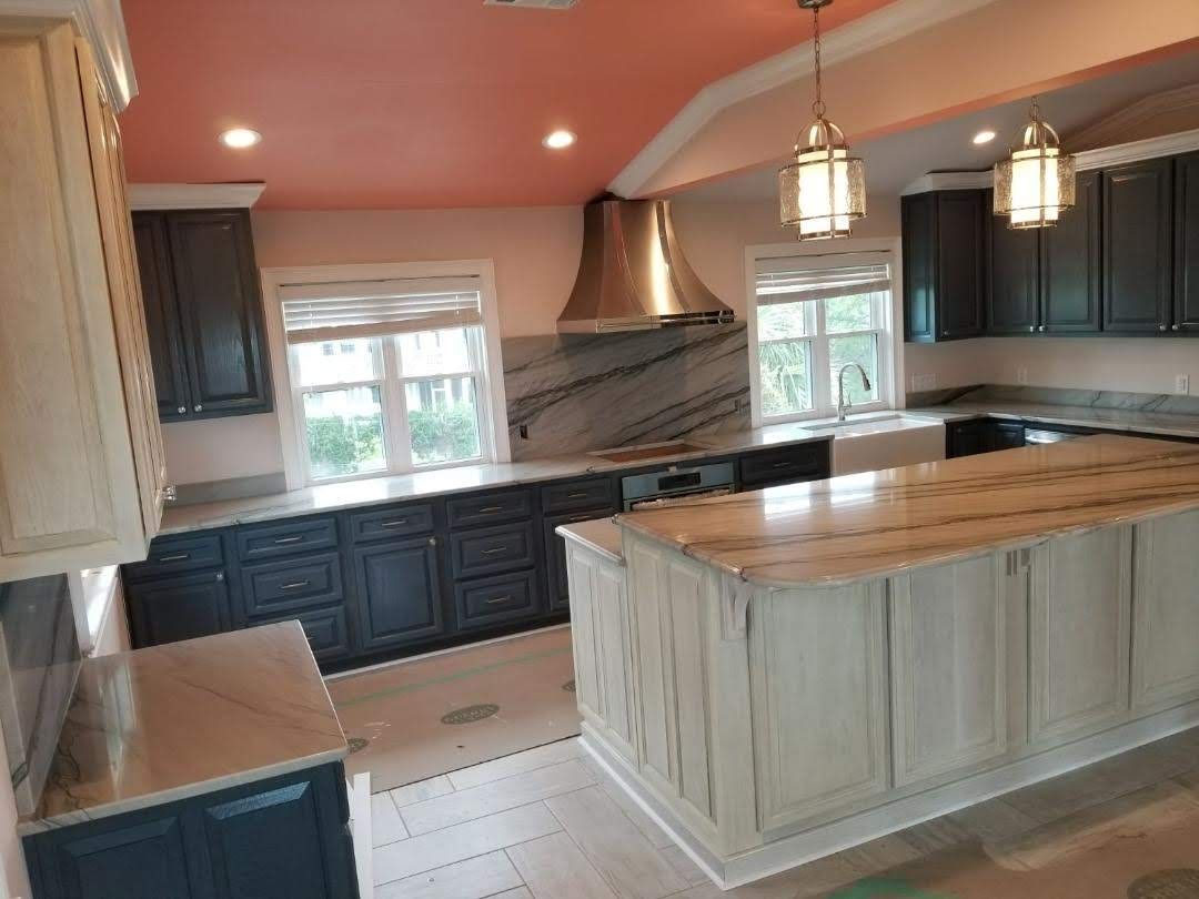 A modern family kitchen with beautiful stone countertops and natural lighting.
