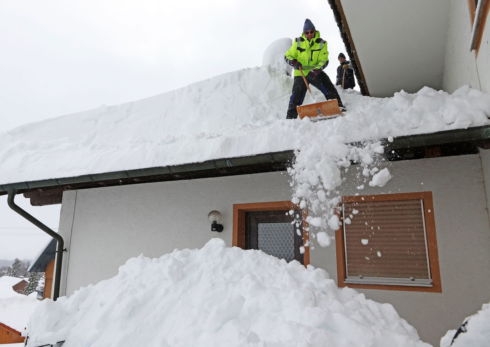 Clearing Snow in the Roof — Torrington, CT — EPB Roofing & Remodeling, LLC Clearing Snow in the Roof — Torrington, CT — EPB Roofing & Remodeling, LLC