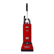 A red vacuum cleaner is sitting on a white surface.