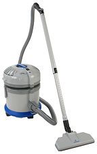 A vacuum cleaner is sitting on top of a white surface.