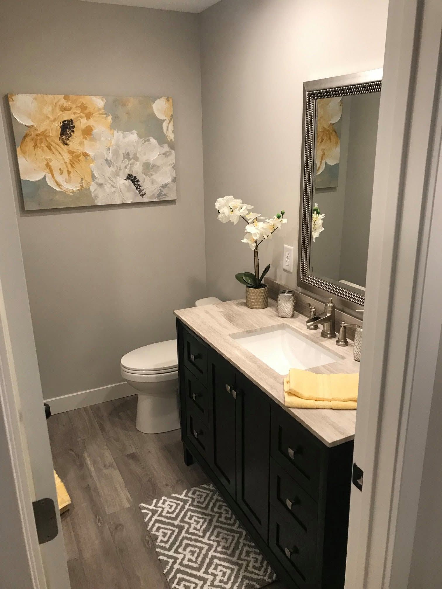 Modern bathroom with double vanity, mirrored cabinets, and glass shower doors