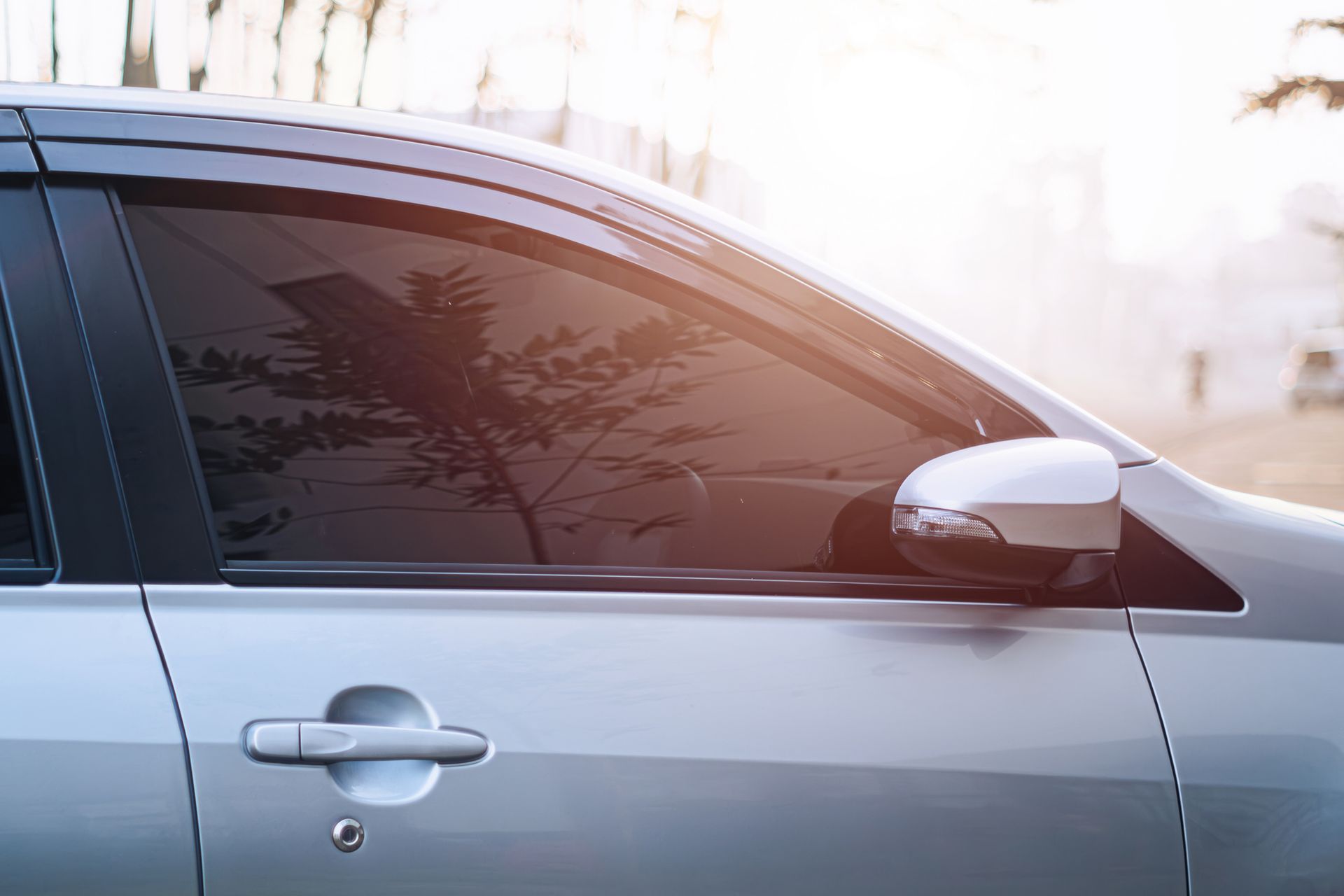 A close up of a car with a tinted window.