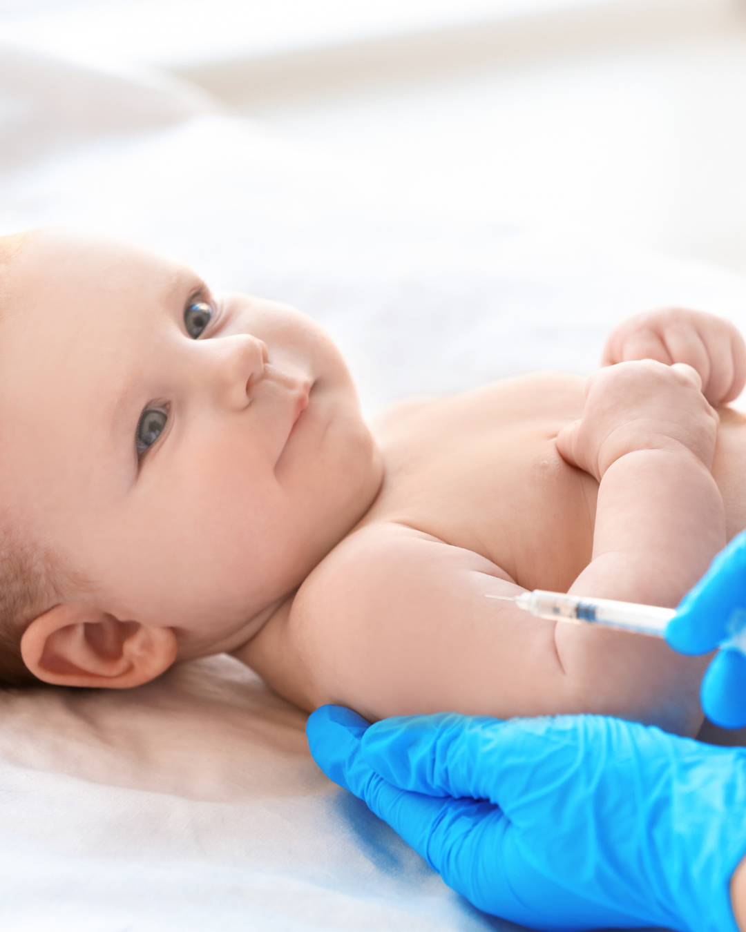 Young baby getting a shot in the arm.
