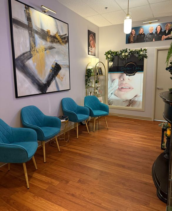 Waiting room with turquoise chairs, abstract art, and a baby photo on the wall.