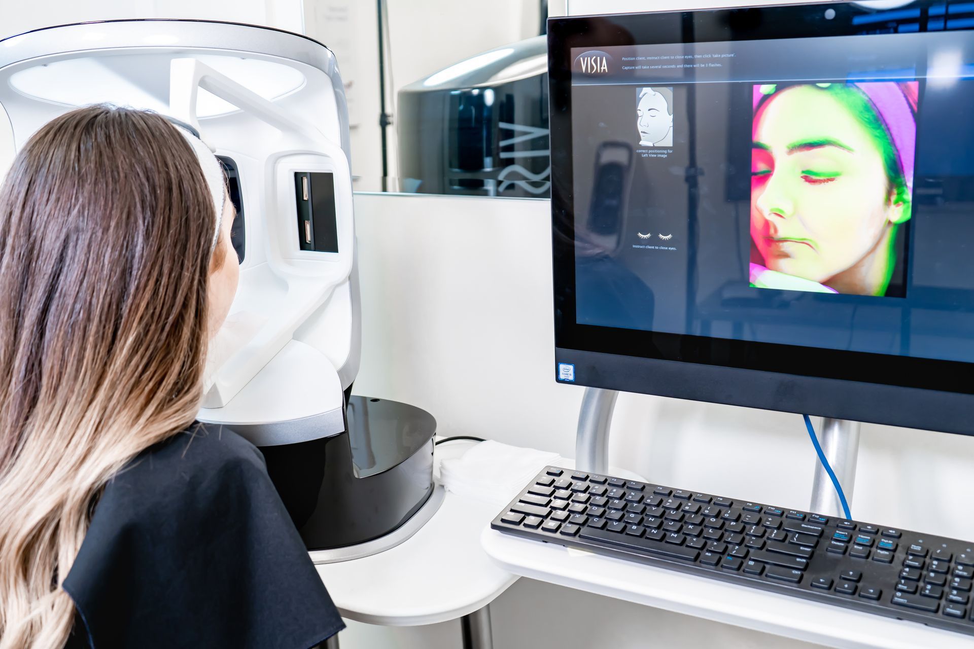 Person viewing a facial analysis screen in a dental/medical clinic setting