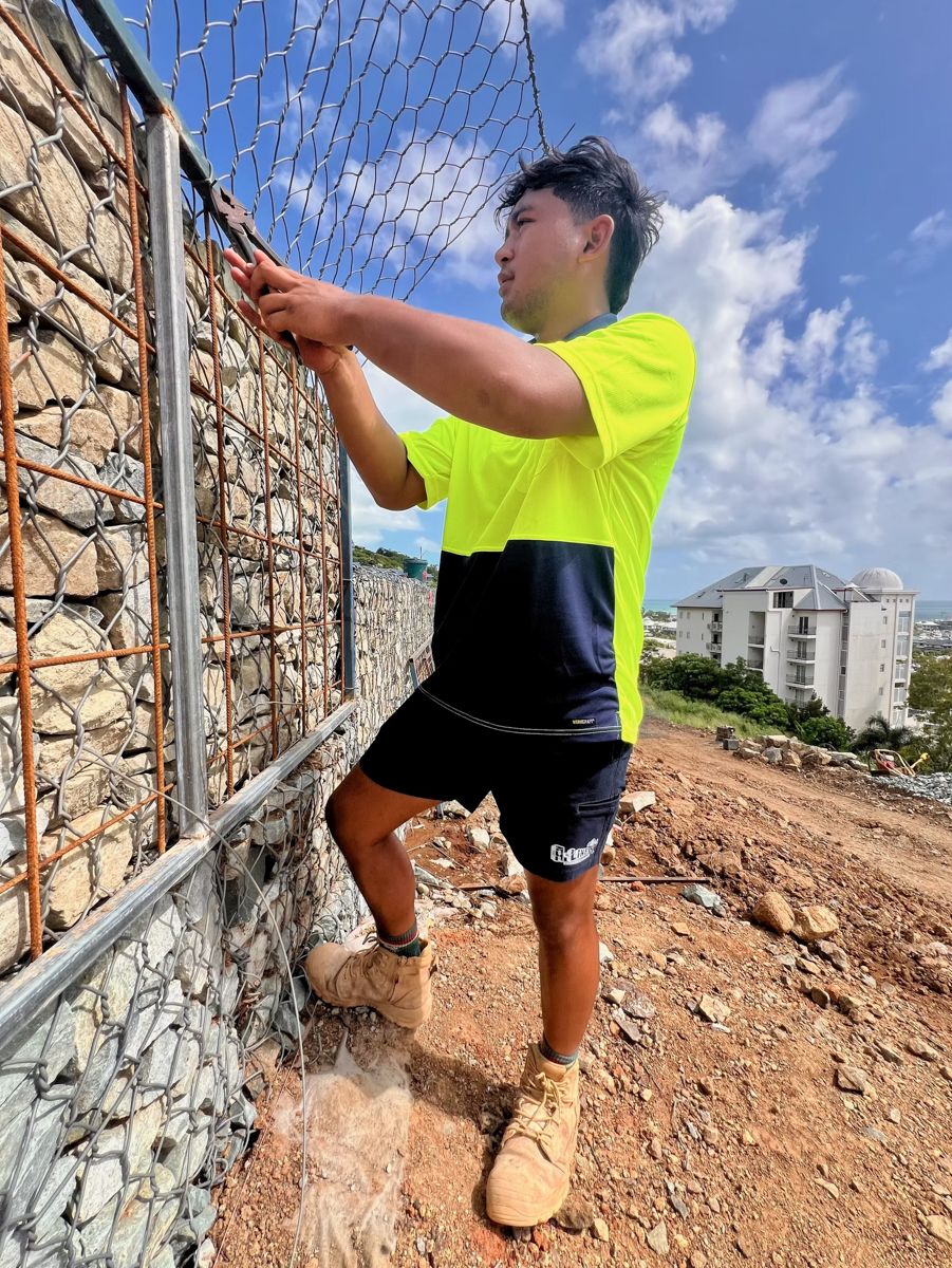 Blog Thumbnail: Worker constructing a gabion wall