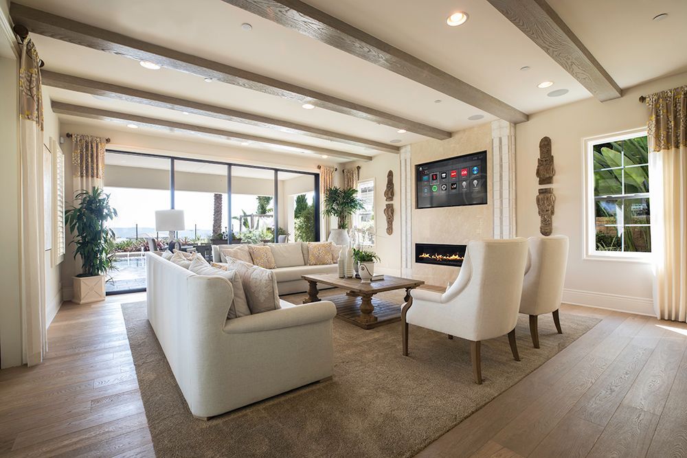 A living room with a couch , chairs , coffee table and television.