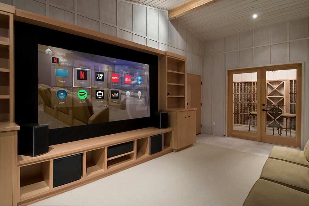 A living room with a large flat screen tv on the wall